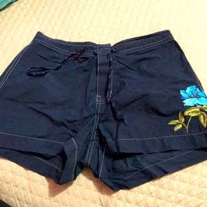Navy blue swim shorts with blue flower